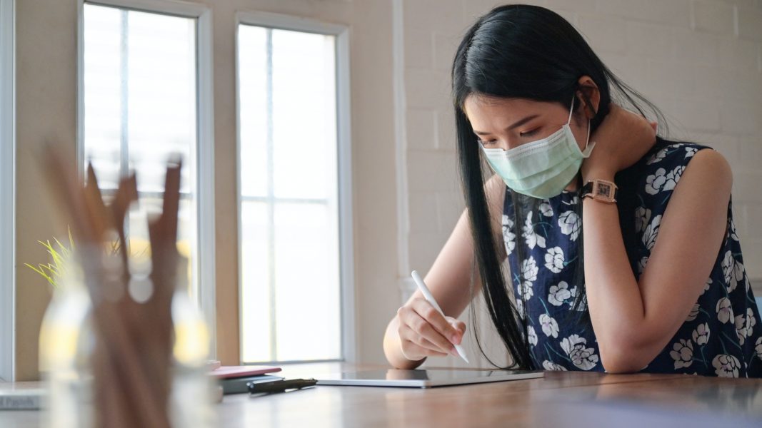 Asian women work at home to prevent the spread of the coronary virus, or Covid-19.